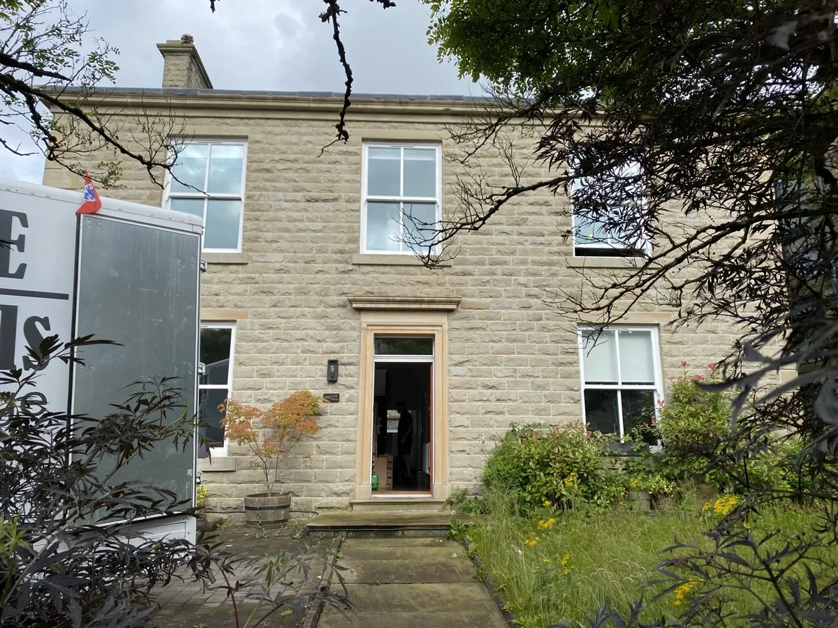 A sandstone house with an overgrown wildflower garden in Loveclough, ahead of a Bridge Removals house clearance. A sandstone house with an overgrown wildflower garden in Loveclough, ahead of a Bridge Removals house clearance.